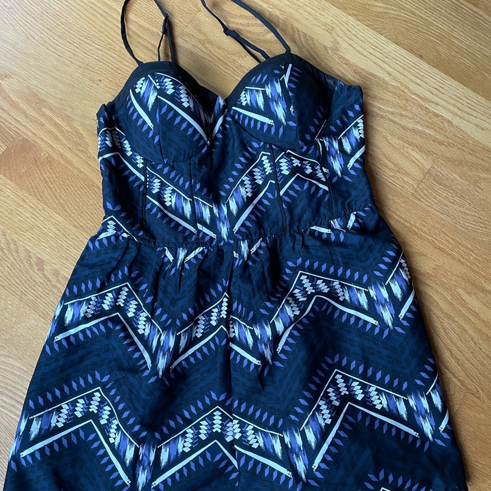 Patterned padded romper. No tags but never worn. Adjustable straps.